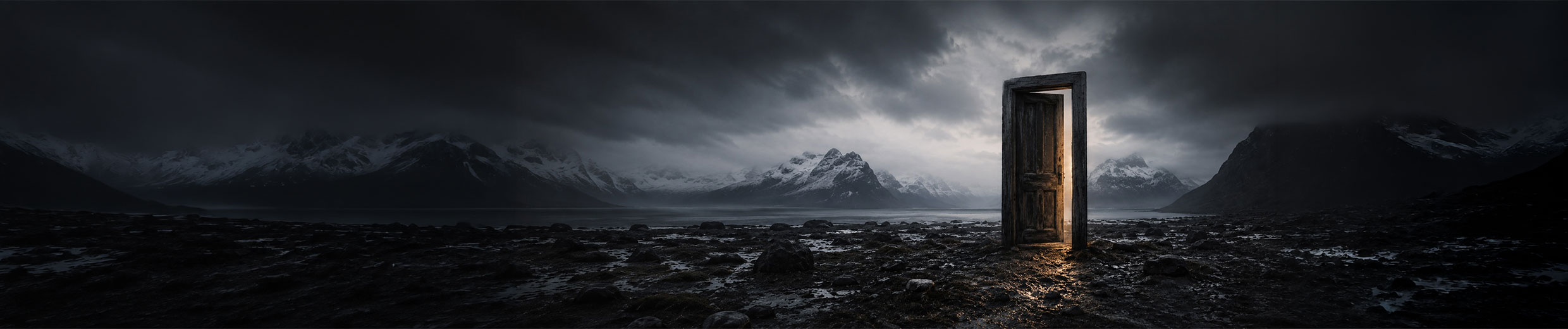 A doorway glowing with warm light on a dark shore beneath mountain peaks